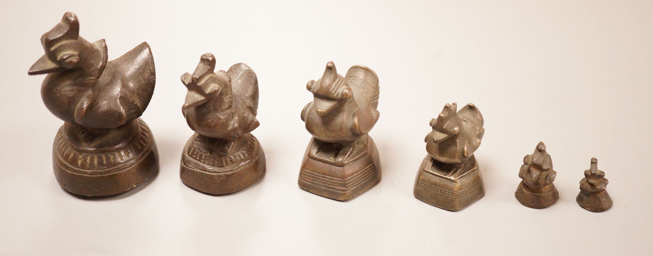 Six Burmese bronze duck opium weights, tallest 7cm
